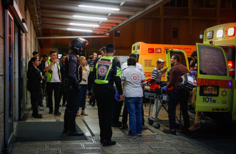 Medics wheel into the emergency room wounded Israeli men from the shooting attack in the West Bank settlement of Kiryat Arba, at the Hadassa Ein Karem Hospital in Jerusalem, on October 29, 2022.  (photo credit: OLIVIER FITOUSSI/FLASH90)