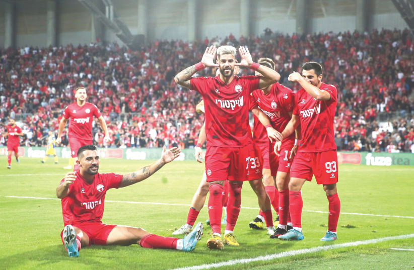  Rotem Hatuel (front) celebrates after his 59th-minute goal during Hapoel Beersheba’s 2-0 victory over visiting Maccabi Tel Aviv on Monday night at Turner Stadium. (photo credit: Liron Moldovan)