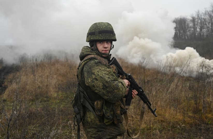  A Russian service member takes part in tactical combat exercises held by a motorised rifle division at the Kadamovsky range in the Rostov region, Russia December 10, 2021 (photo credit: REUTERS/SERGEY PIVOVAROV)