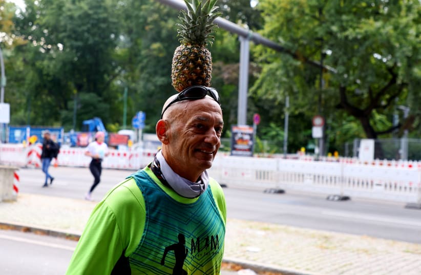  A runner wearing a pineapple during the September Berlin Marathon (photo credit: Fabrizio Bensch/Reuters)