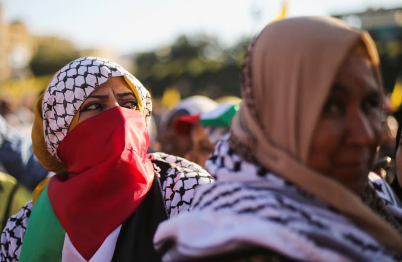  Palestinians take part in a Fatah rally marking the 18th anniversary of the death of late Palestinian leader Yasser Arafat, in Gaza City (photo credit: REUTERS)