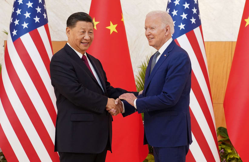 US President Joe Biden shakes hands with Chinese President Xi Jinping as they meet on the sidelines of the G20 leaders' summit in Bali, Indonesia, November 14, 2022. (photo credit: REUTERS/KEVIN LAMARQUE)