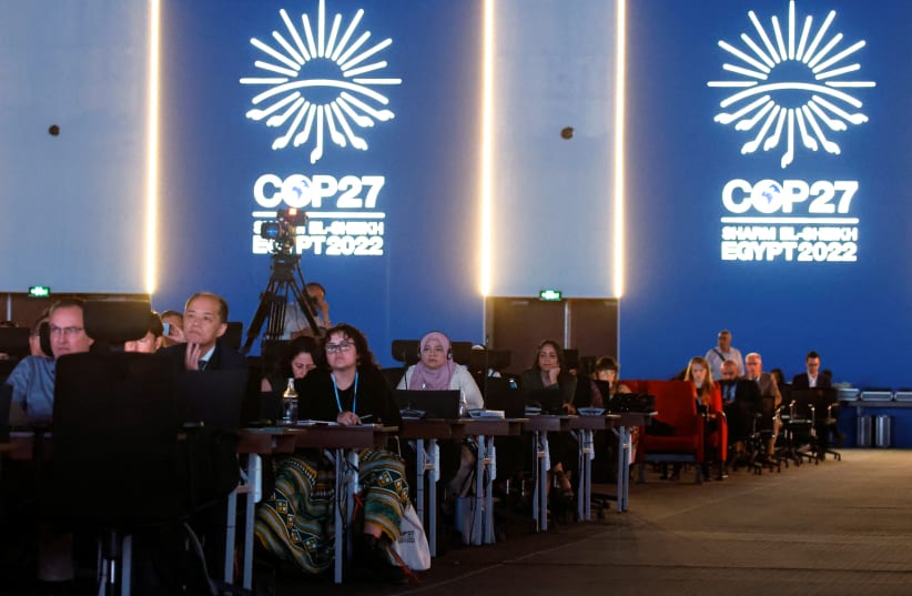  People listen as they attend the COP27 climate summit at the Red Sea resort of Sharm el-Sheikh, Egypt November 9, 2022. (photo credit: REUTERS/MOHAMMED SALEM)