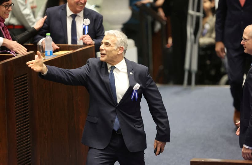 Outgoing Prime Minister Yair Lapid during the swearing-in ceremony for the new Israeli parliament on the 25th Knesset in Jerusalem, 15 November 2022. (photo credit: ABIR SULTAN/POOL/VIA REUTERS)