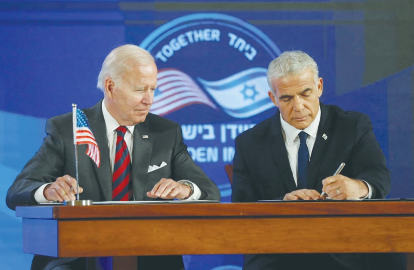  PRIME MINISTER Yair Lapid and US President Joe Biden sign a security pledge in Jerusalem, in July. (photo credit: ATEF SAFADI/REUTERS)