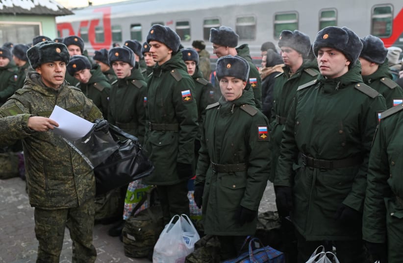 Russian conscripts called up for military service line up before boarding a train as they the depart for garrisons at a railway station in Omsk, Russia, November 27, 2022. (photo credit: REUTERS/ALEXEY MALGAVKO)