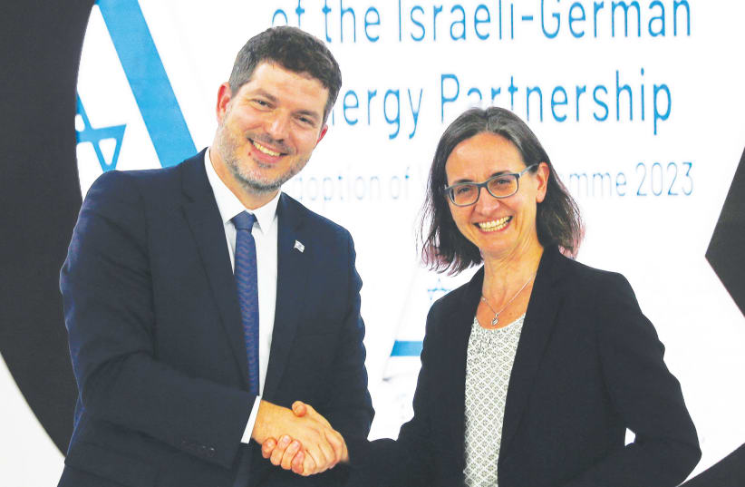  LIOR SCHILLAT, director-general of the Energy Ministry, shakes hands with Birgit Schwenk, director-general for climate action at the German Ministry for Economic Affairs and Climate Action, after signing a working plan for energy cooperation, at COP27 in Sharm e-Sheikh, earlier this month.  (photo credit: THAIER AL-SUDANI/REUTERS)