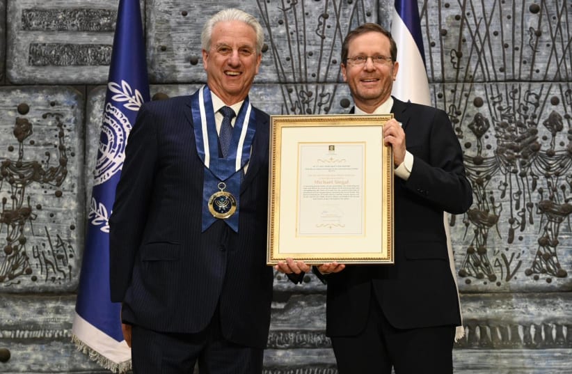  Michael Siegal (left) receiving the Israeli Presidential Medal of Honor from President Isaac Herzog (photo credit: CHAIM ZACH / GPO)