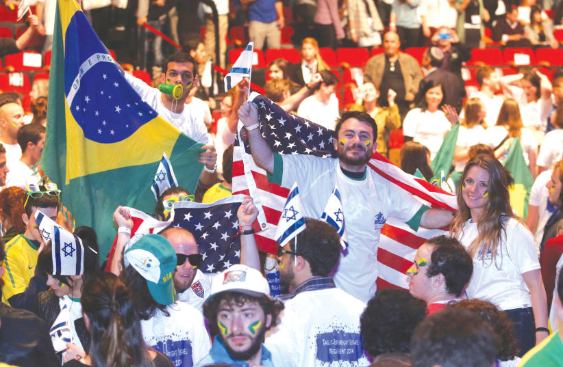  PARTICIPANTS CELEBRATE at an annual Birthright event, at the Jerusalem International Convention Center in 2014. If US Jews need a free trip to convince them to travel to Israel, the future of the community is catastrophic, says the writer.  (photo credit: Marc Israel Sellem/Jerusalem Post)