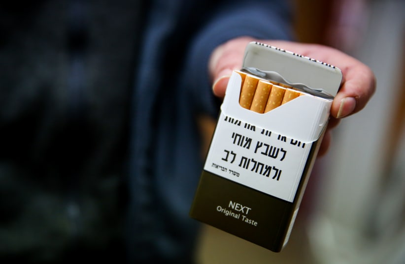  Cigarette packets highlighting the health risks of smoking shown at a convenience store in Tzfat, northern Israel, December 20, 2019. (photo credit: DAVID COHEN/FLASH 90)