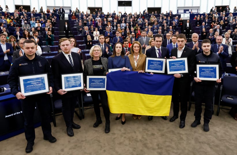 Representatives of Ukrainian civil society pose with European Parliament President Roberta Metsola after receiving the Sakharov Prize in the name of the people of Ukraine and Ukrainian President Volodymyr Zelenskiy, at the European Parliament in Strasbourg, France December 14, 2022. (photo credit: YVES HERMAN/REUTERS)