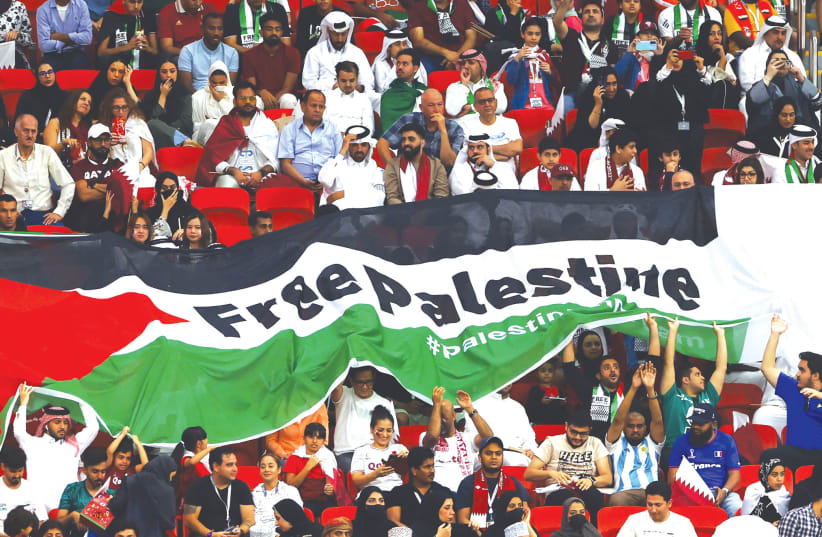  FANS HOLD up a large Palestinian flag with the message ‘Free Palestine,’ at a World Cup match between the Netherlands and Qatar at Al Bayt Stadium, Al Khor, Qatar, last month.  (photo credit: Bernadett Szabo/Reuters)
