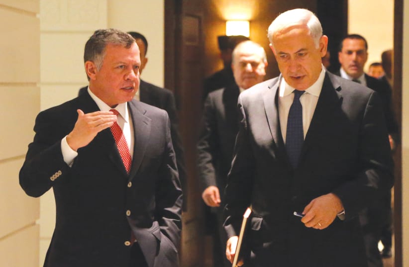  THEN-PRIME minister Benjamin Netanyahu walks with Jordan’s King Abdullah II before their meeting at the Royal Palace in Amman, in 2014 (photo credit: JORDANIAN ROYAL PALACE/REUTERS)