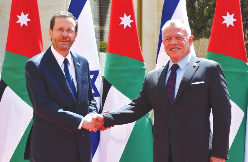  PRESIDENT ISAAC HERZOG shakes hands with Jordan’s King Abdullah II in Amman, last year. It’s ridiculous that the Israel-Jordan peace deal gives the kingdom a special role at the Temple Mount, says the writer. (photo credit: HAIM ZACH/GPO)