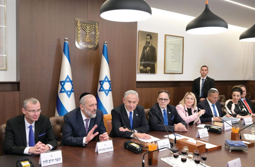  Israeli Prime Minister Benjamin Netanyahu is seen at a meeting of his new cabinet in Jerusalem. (photo credit: AMOS BEN-GERSHOM/GPO)