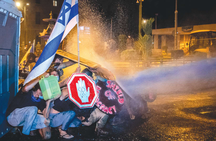  Israeli Police use a water cannon to disperse demonstrators during a protest against Benjamin Netanyahu in Jerusalem in 2020. Are these images coming back? (photo credit: YONATAN SINDEL/FLASH90)