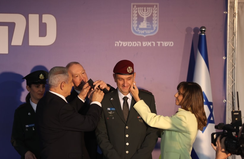  IDF chief of Staff Lt.-Gen. Herzi Halevi receiving his rank from PM Netanyahu, Defense Minister Galant and his wife. (photo credit: ALEX KOLOMOISKY/POOL)