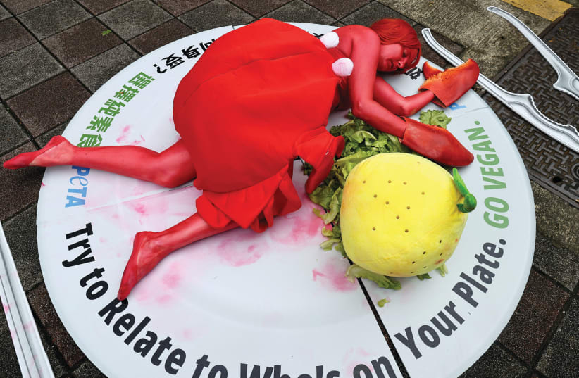  AN ANIMAL rights activist body-painted as a crab at the fish market in Taipei, Taiwan.  (photo credit: ANN WANG/REUTERS)