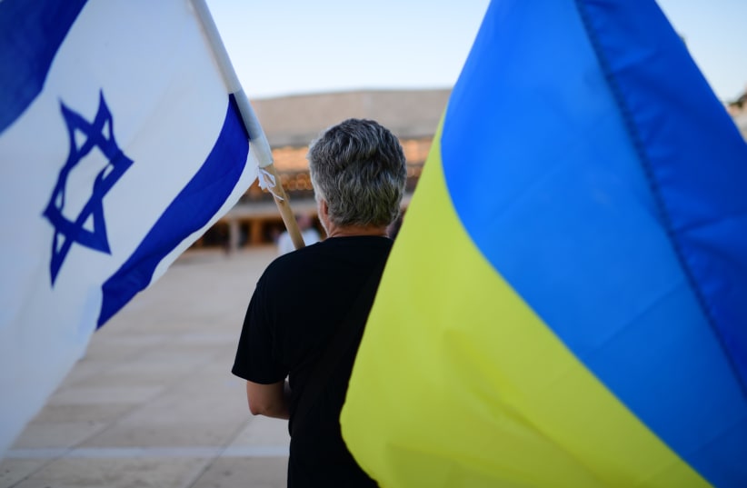  Demonstrators carry placards and flags during a protest against the Russian invasion to the Ukraine in Tel Aviv on August 24, 2022.  (photo credit: TOMER NEUBERG/FLASH90)