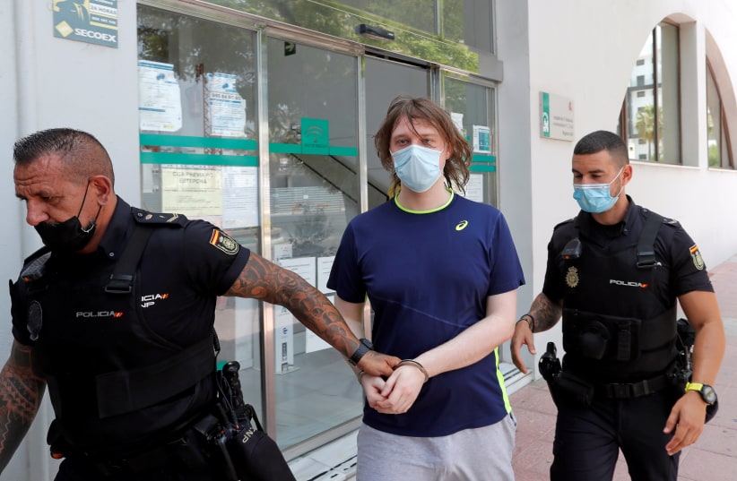 22-year-old British citizen Joseph James O'Connor is led by Spanish police officers as he leaves a court after being arrested in connection with an alleged July 2020 Twitter hack that compromised the accounts of high-profile politicians and celebrities, according to the US Justice Department. (photo credit: REUTERS/JON NAZCA)