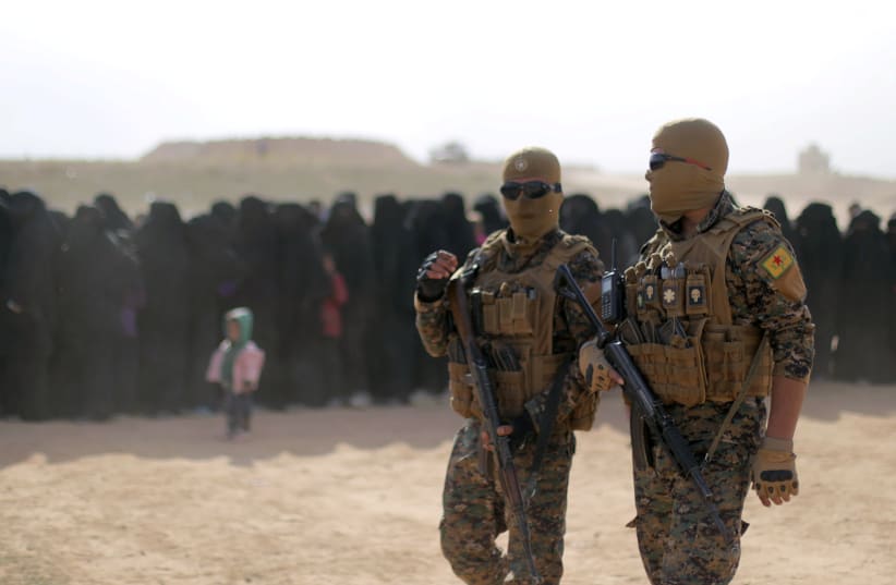 Fighters of Syrian Democratic Forces (SDF), walk together near Baghouz, Deir Al Zor province, Syria March 5, 2019. (photo credit: REUTERS/RODI SAID)