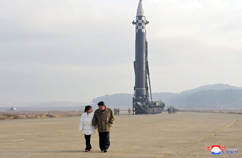  North Korean leader Kim Jong Un, along with his daughter, walks away from an intercontinental ballistic missile (ICBM) in this undated photo released on November 19, 2022 (photo credit: REUTERS)