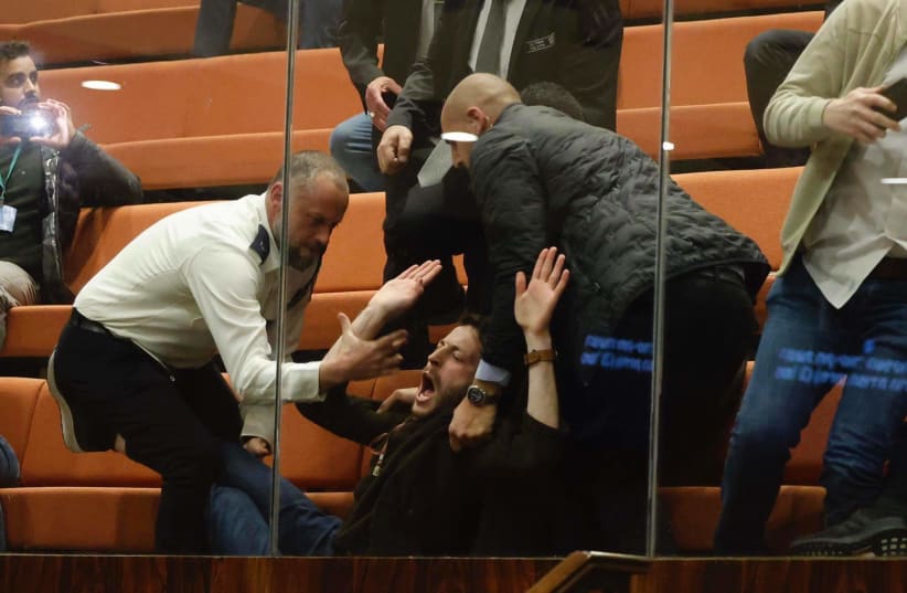  Protesters are seen being removed from the Israeli Knesset ahead of a planned vote on judicial reform, in Jerusalem, on February 20, 2023. (photo credit: MARC ISRAEL SELLEM/THE JERUSALEM POST)