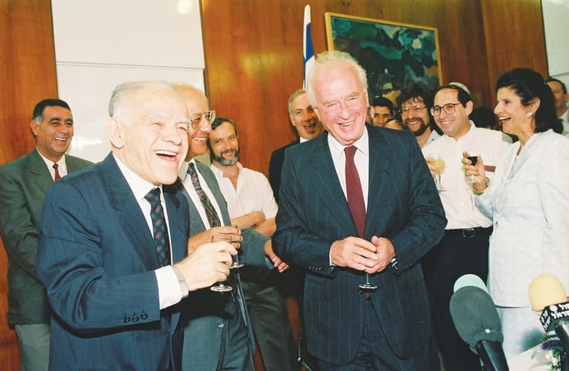  OUTGOING PRIME minister Yitzhak Shamir raises a glass with Yitzhak Rabin, on the day of the Rabin government’s inauguration on July 13, 1992. Attention was diverted from the constitutional revolution to the Oslo Accords, says the writer. (photo credit: YOSSI ZAMIR/FLASH90)