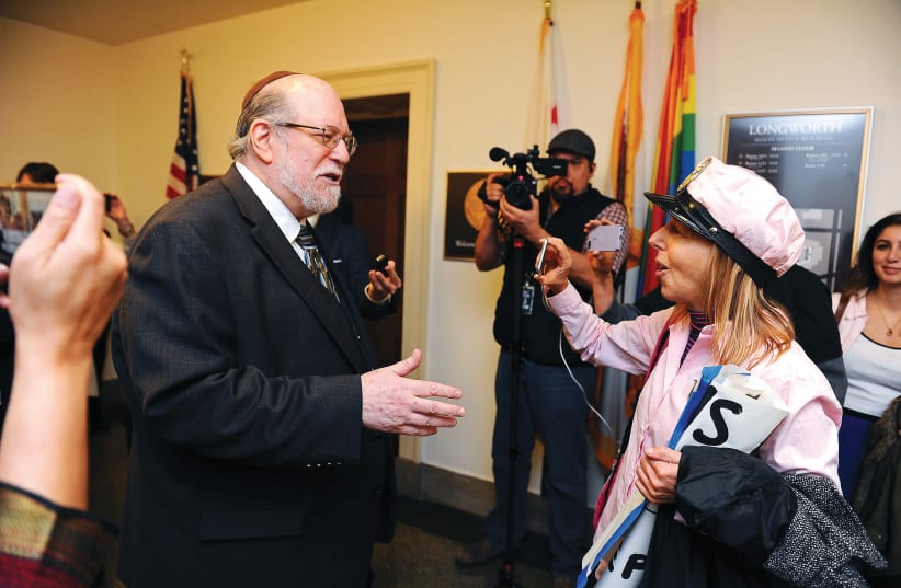  RABBI ARYEH SPERO of the National Conference of Jewish Affairs debates Medea Benjamin of Code Pink in Washington, in 2019. (photo credit: MARY F. CALVERT / REUTERS)
