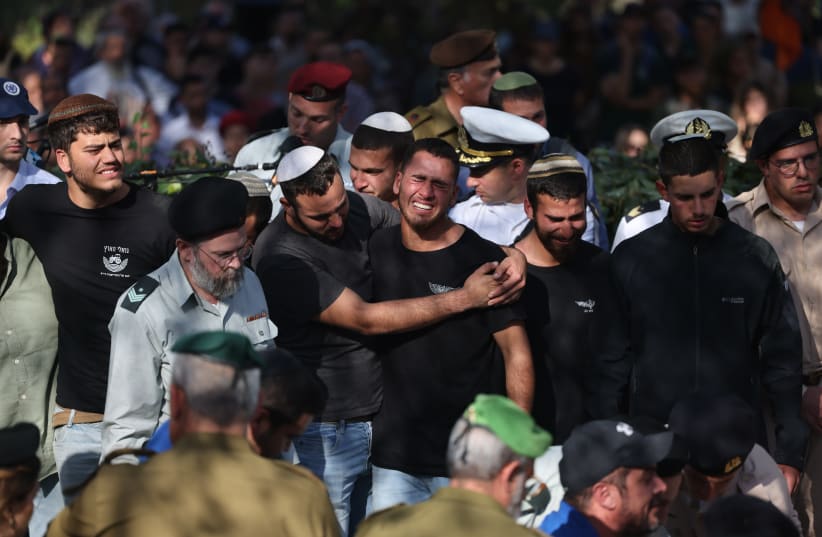  Friends and family attend the funeral of brothers Hallel, 21, and Yagel Yaniv, 19, at Mount Herzl military cemetery in Jerusalem. The two brothers were shot dead last night in a terror attack in the West Bank city of Huwara. February 27, 2023.  (photo credit: YONATAN SINDEL/FLASH90)