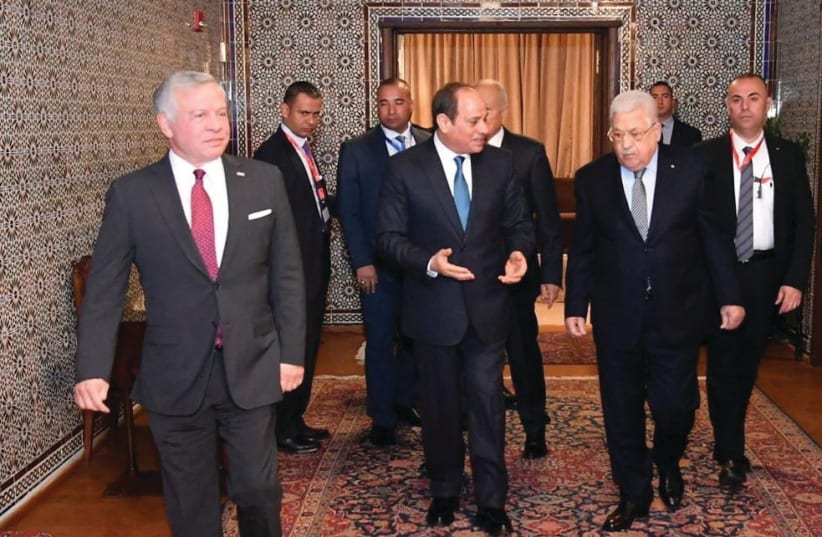  EGYPTIAN PRESIDENT Abdel Fattah al-Sisi (center) speaks with Palestinian Authority head Mahmoud Abbas as Jordan’s King Abdullah walks ahead, after a conference of Arab leaders in Cairo, last month.  (photo credit: Egyptian Presidency/Reuters)