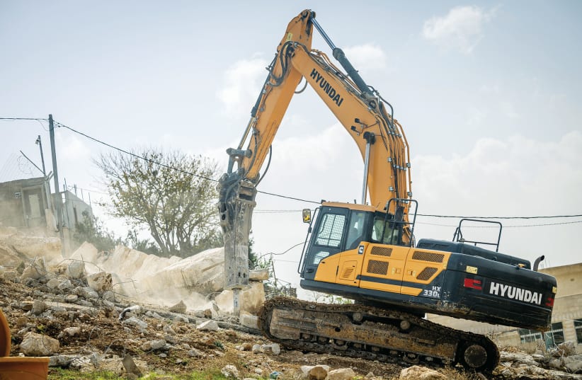  AUTHORITIES DEMOLISH a structure in the eastern Jerusalem neighborhood of Sur Baher, last month. Last year, the High Court froze the demolitions of 38 homes in eastern Jerusalem.  (photo credit: YONATAN SINDEL/FLASH90)