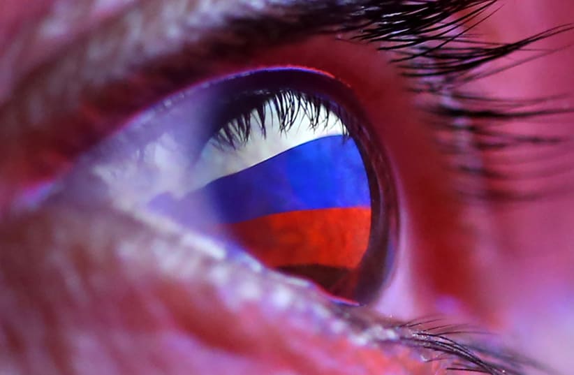 A Russian flag is reflected in an eye in this picture illustration taken October 4, 2018. (photo credit: REUTERS/DADO RUVIC/ILLUSTRATION)