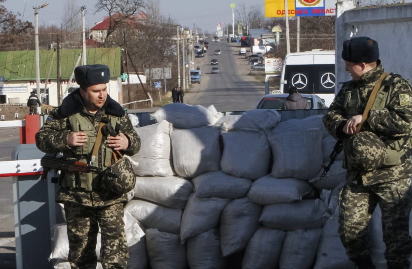  Ukrainian border guards stand at a checkpoint at the border with Moldova breakaway Transnistria region, near Odessa March 13, 2014.  (photo credit: REUTERS/Yevgeny Volokin)