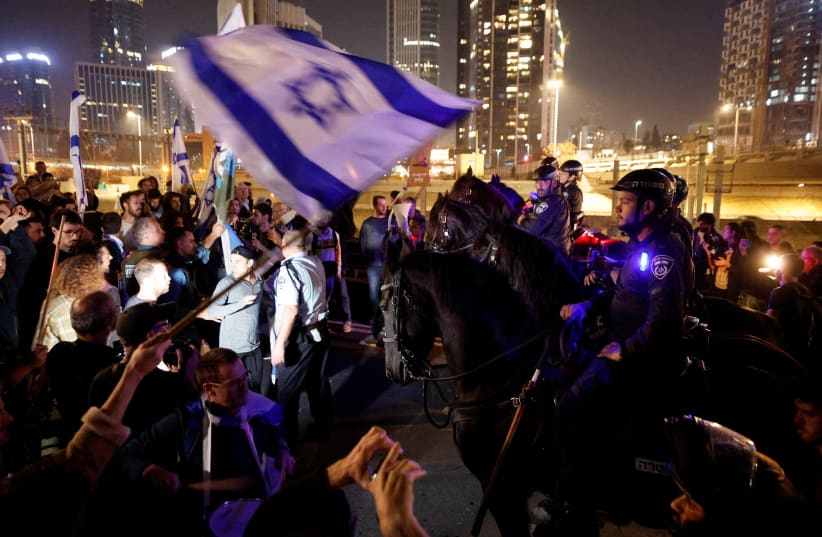 Mounted police stand in front of people during a demonstration, as Israeli Prime Minister Benjamin Netanyahu's nationalist coalition government presses on with its contentious judicial overhaul, in Tel Aviv, Israel, March 4, 2023. (photo credit: REUTERS/AMIR COHEN)