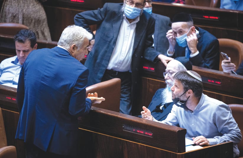  THEN-FOREIGN MINISTER Yair Lapid and then-opposition member MK Bezalel Smotrich engage in an animated conversation in the Knesset, in 2021. The current coalition and opposition have both failed us, says the writer. (photo credit: YONATAN SINDEL/FLASH90)
