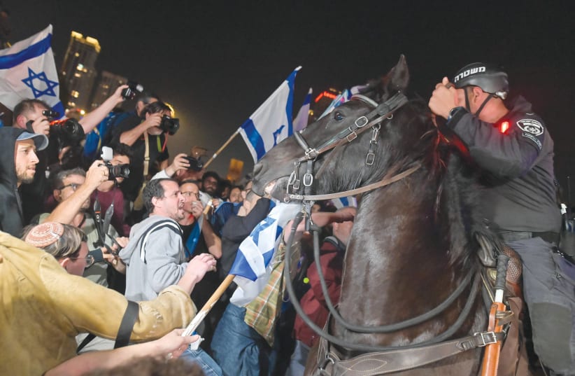  TEL AVIV last weekend: The Saturday night demonstrations and the street riots are not about the proposed legal changes or democracy, says the writer. (photo credit: TOMER NEUBERG/FLASH90)