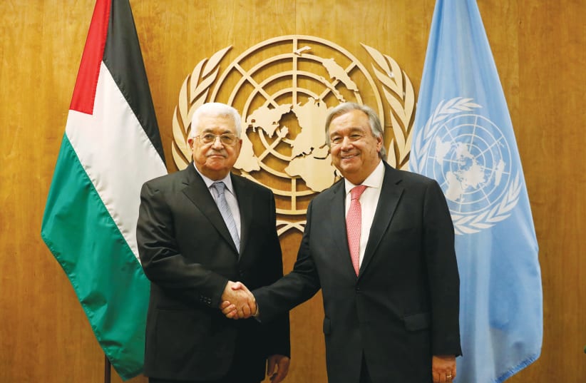  PA HEAD Mahmoud Abbas is greeted by UN Secretary-General António Guterres at UN Headquarters in New York, in 2017. Last month, Guterres pointed to the importance of restoring ‘a credible political horizon.’  (photo credit: BRENDAN MCDERMID/REUTERS)