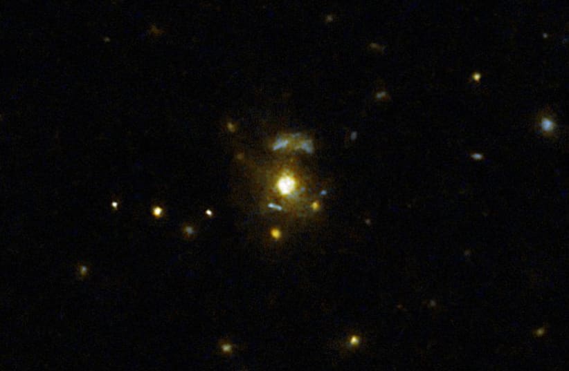  This image taken with the NASA/ESA Hubble Space Telescope shows the galaxy 3C 297, which was part of a large survey of galaxies. The galaxies in the pictures look close on a 2D image, but in reality they're in completely different parts of space. (photo credit: NASA, ESA, M. Chiaberge (STScI))
