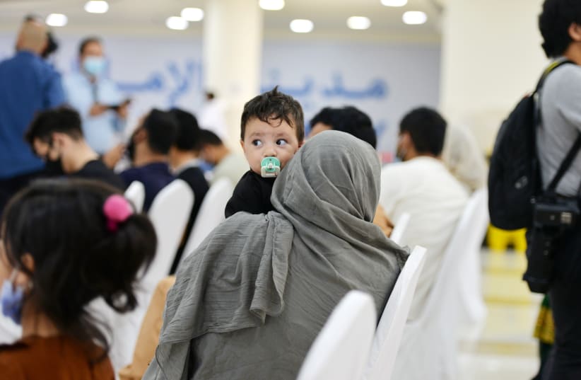  Evacuees from Afghanistan sit at Emirates Humanitarian City in Abu Dhabi, UAE, August 28, 2021 (photo credit: REUTERS)