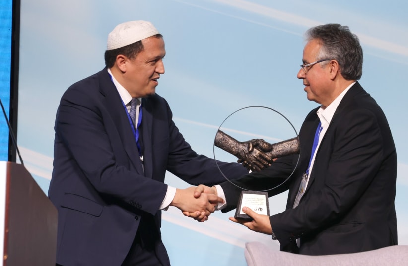  Sheikh Hassen Chalghoumi (left) receiving his badge from Aharon Azoulay, head of Hamifrats  (photo credit: the Municipal Authorities Cluster of the Gulf)