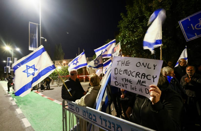  People demonstrate outside the residence of Israeli President Isaac Herzog as he hosts talks over judicial reforms, in Jerusalem, March 28, 2023. (photo credit: RONEN ZVULUN/REUTERS)