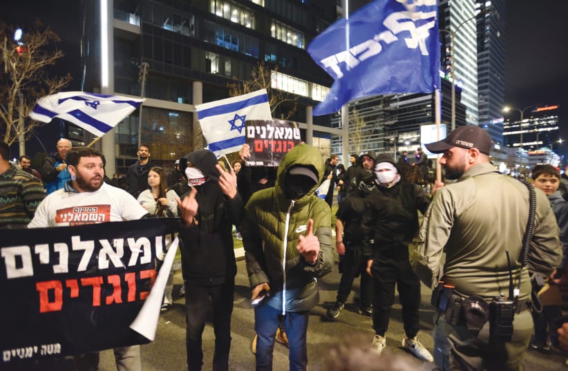  SIGNS WITH the slogan ‘leftists are traitors’ are held by protesters at a right-wing rally in Tel Aviv, last month. (photo credit: GILI YAARI /FLASH90)