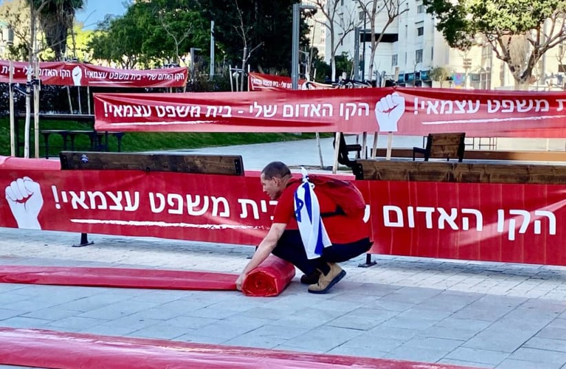  Signs at an IDF reservists demonstration against the judicial reform in Tel Aviv, April 4, 2023. (photo credit: AVSHALOM SASSONI/MAARIV)