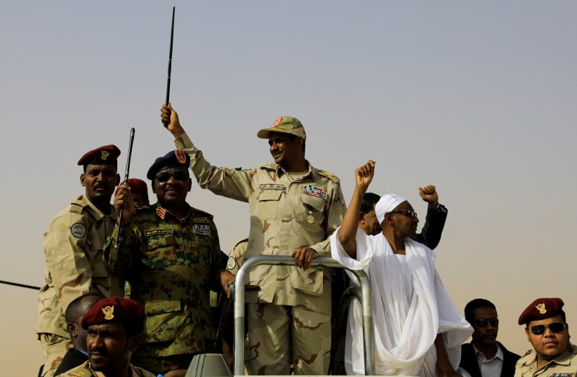  : Lieutenant General Mohamed Hamdan Dagalo, deputy head of the military council and head of paramilitary Rapid Support Forces (RSF), greets his supporters as he arrives at a meeting in Aprag village, 60 kilometers away from Khartoum, Sudan, June 22, 2019. (photo credit: REUTERS/UMIT BEKTAS/FILE PHOTO)