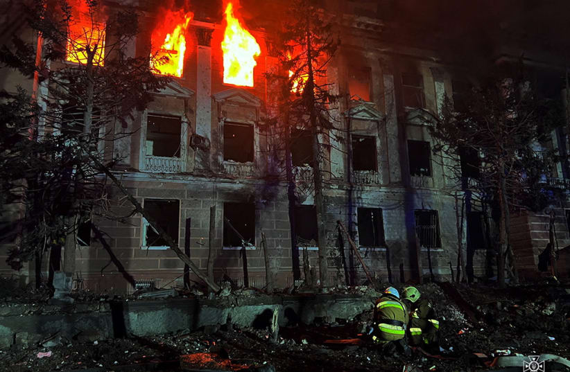Firefighters work at a site of a building damaged by a Russian missile strike, amid Russia's attack on Ukraine, in Mykolaiv, Ukraine April 27, 2023.  (photo credit: Press service of the State Emergency Service of Ukraine in Mykolaiv region/Handout via REUTERS)