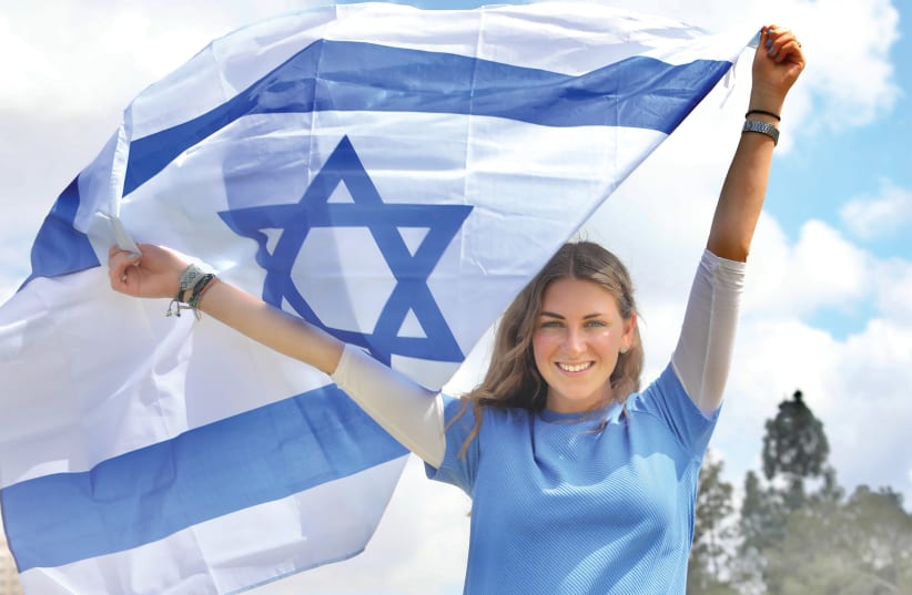  Teli Esther Raphel (now Michaan), who made aliyah from Mexico, holds up an Israeli flag to celebrate Independence Day. (photo credit: MARC ISRAEL SELLEM)