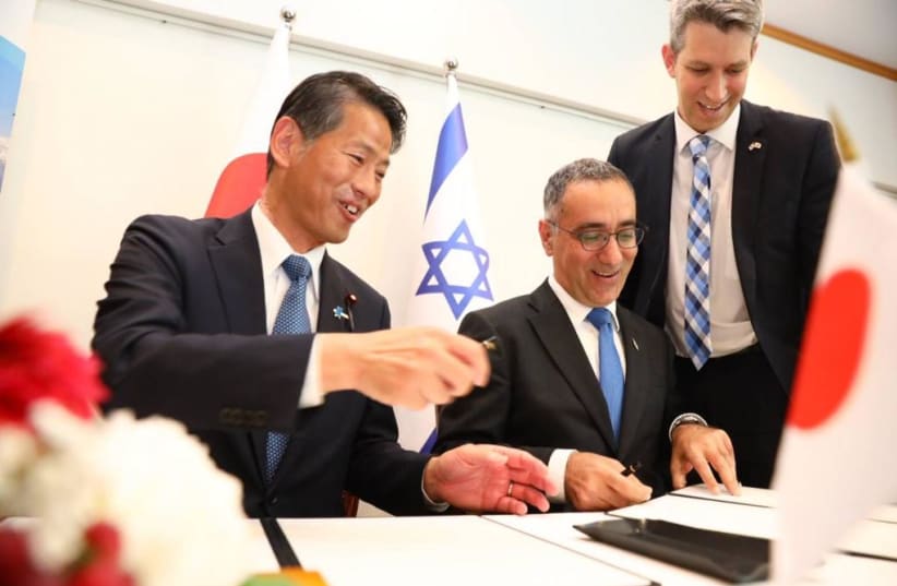  Israeli Ambassador to Japan Gilad Cohen and Japanese Foreign Minister Kenji Yamada sign the "work-holiday" visa agreement in April 2023.  (photo credit: PAOLO FOCOCCI )