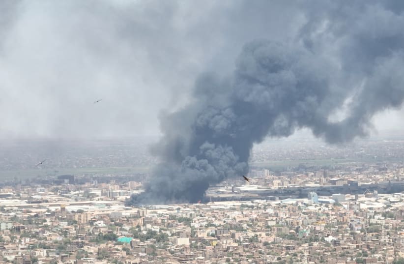  Drone footage shows birds in the foreground as clouds of black smoke billow over Bahri, also known as Khartoum North, Sudan, in this May 1, 2023 video obtained by REUTERS. (photo credit: VIA REUTERS)