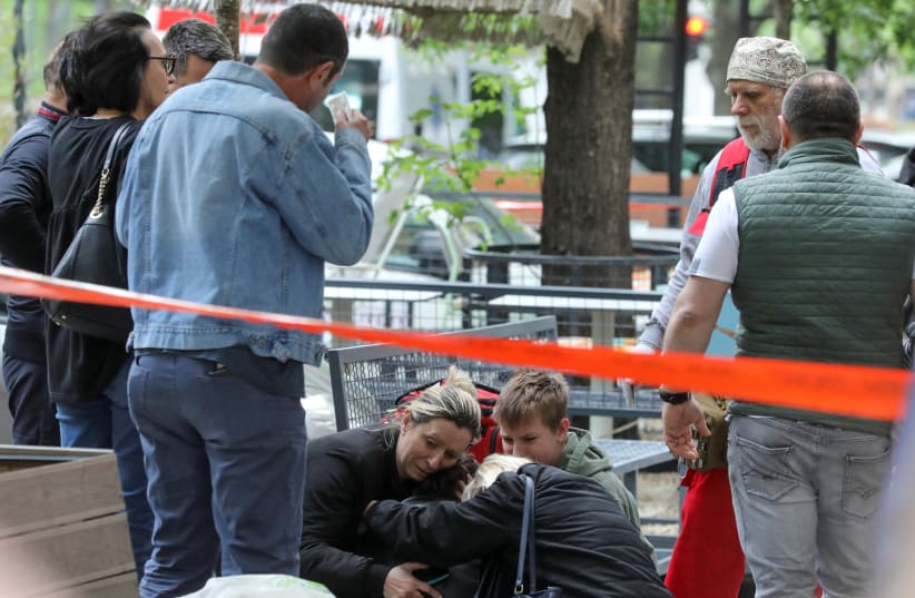  People react after a 14-year-old boy opened fire on other students and security guards at a school in downtown Belgrade, Serbia, May 3, 2023 (photo credit: REUTERS)